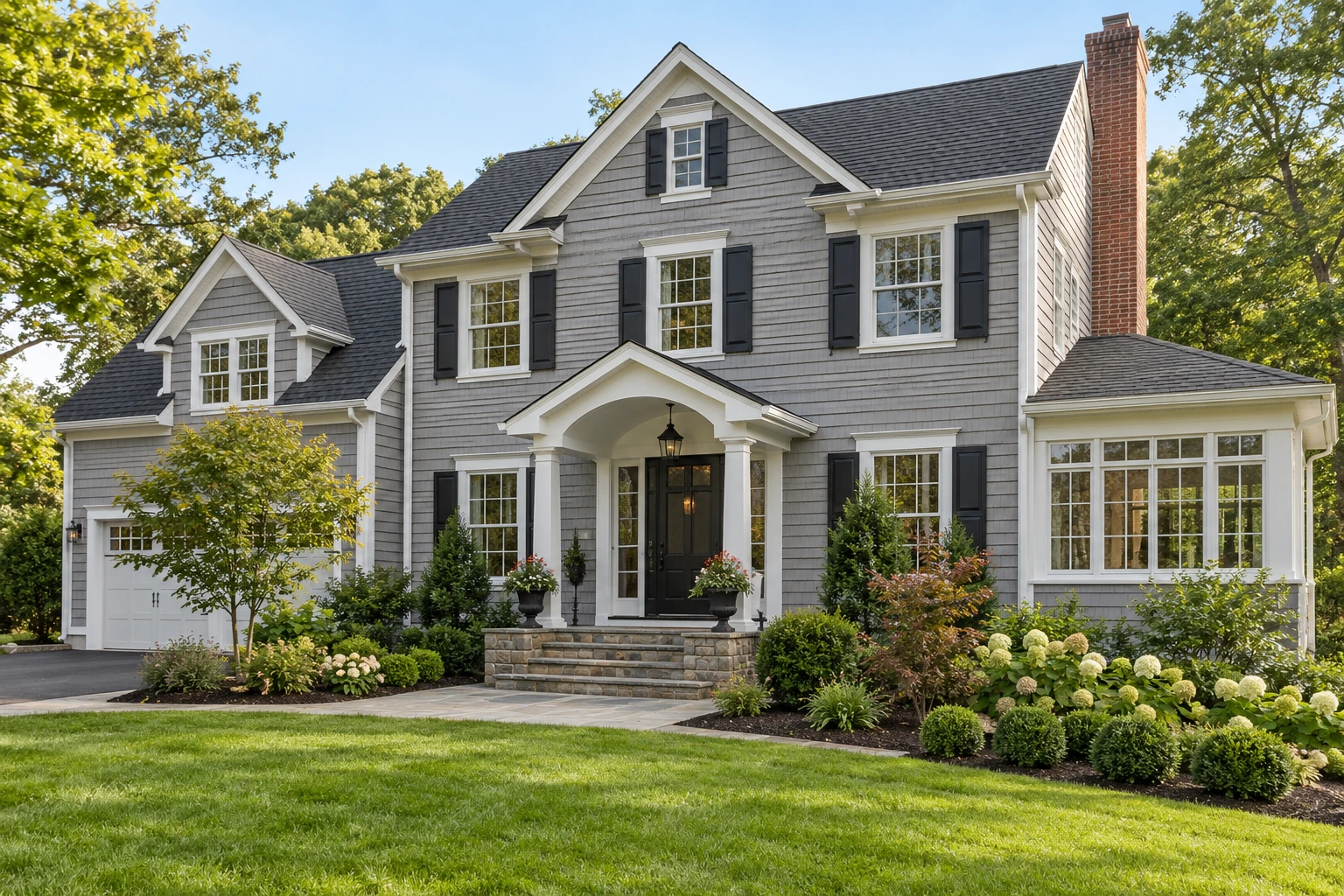 Home exterior with siding, stone steps, roofing, chimney and gutters